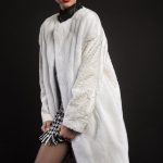 Collarless white mink coat with swakara sleeves